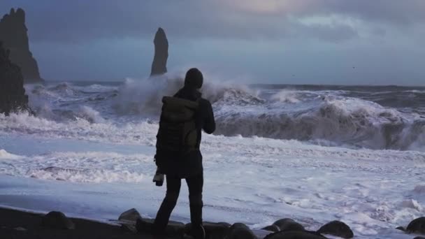 Photographer On Black Sand Beach Watching Stormy Sea — Video