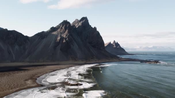 Drone por encima de la marea y la playa con vista de Vestrahorn — Vídeos de Stock