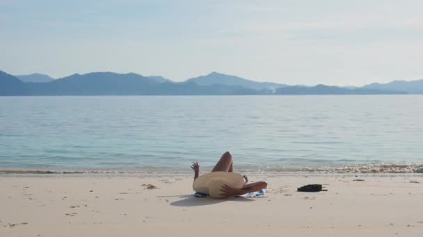 Woman In Sunhat Sunbathing By Sea On Beach — Stock video