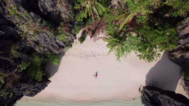 Drone Of Woman Sitting On Entalula Beach — стоковое видео