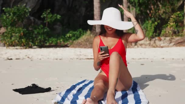 Young Woman Sitting On Beach With Smartphone — ストック動画