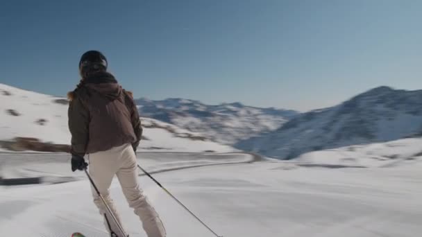 Młoda kobieta zatrzymuje się na stoku narciarskim — Wideo stockowe