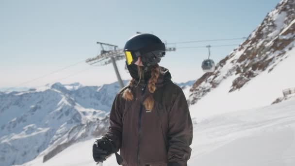 Woman In Reflective Ski Visor On Ski Slope With Cable Car Behind — Video Stock
