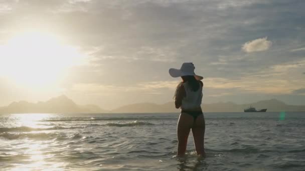 Woman In Thong And Sun Hat Watching Sun Set — Wideo stockowe