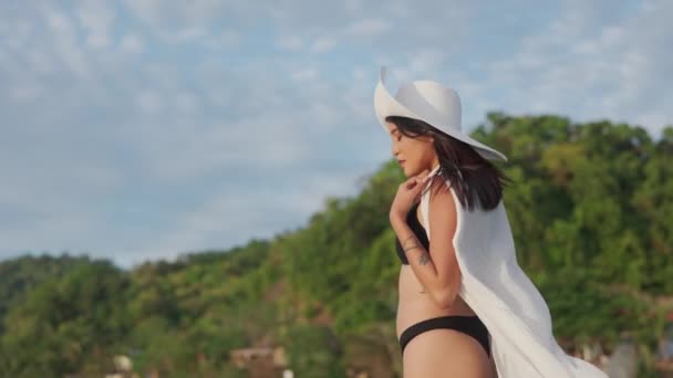 Młoda kobieta w bikini i kapelusz na morzu — Wideo stockowe