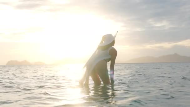Woman In Thong Splashing Water In Sea Towards Glowing Sunset — Wideo stockowe