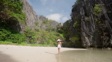 Woman Walking Along Sunlit Hidden Beach