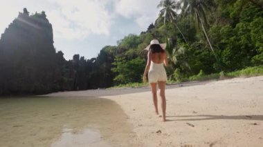 Woman Walking Along Hidden Beach