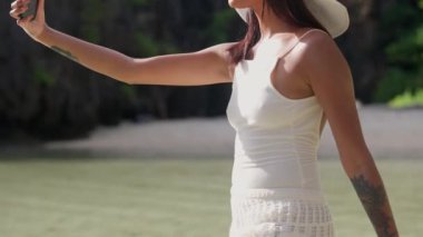 Woman Smiling In Sun Hat To Pose For Selfie On Smartphone