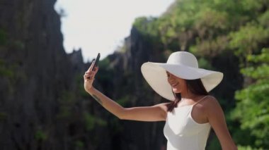 Woman Smiling In Sun Hat To Pose For Selfie On Smartphone