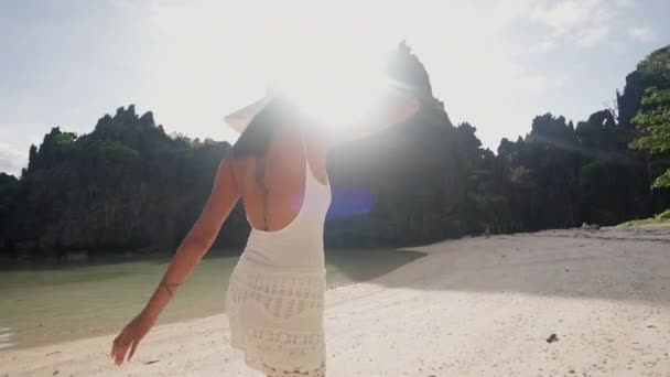 Woman In Sun Hat Turning To Walk Along Beach — Stockvideo