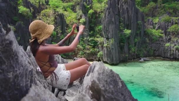 Woman Sitting On Limestone Rocks Taking Photo With Smartphone — Wideo stockowe