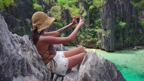 Woman Sitting On Limestone Rocks Taking Photo With Smartphone — Stockvideo