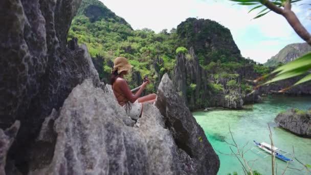 Woman Sitting On Limestone Rocks Taking Selfie With Smartphone — Vídeos de Stock