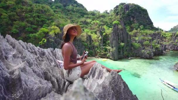 Woman Sitting On Limestone Rocks Holding Smartphone — Stockvideo