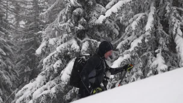 Wide Slow Motion Tracking Handheld Shot Man Ski Touring Uphill — Stockvideo