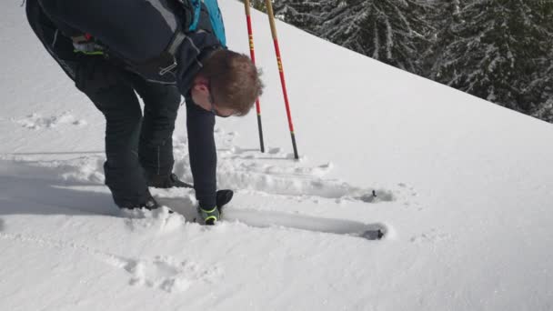 Slow Motion Medium Tracking Shot Man Wyciągający Narty Głębokiego Śniegu — Wideo stockowe