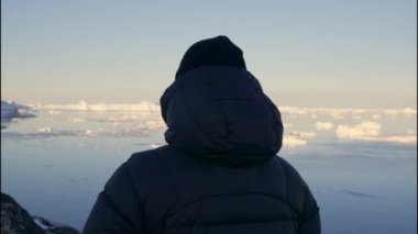 Ilulissat Icefjord, Grönland 'da Ilulissat Denizi' ne bakan Sıcak Giysili Adam Çekimi