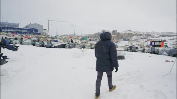 Medium Handheld Slow Motion Tracking Shot Man Winter Coat Walking — стоковое видео