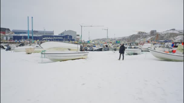 Wide Lockdown Shot Man Winter Wear Walking Amongst Moored Boats — стокове відео