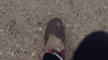 POV Shot of a Man Walks in Wet Muddy Boots on the Ground. Slow Motion Shot