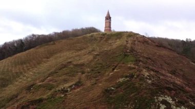 Aerial Over Red Brick Tower on the Top of Himmelbjerget Hill, Denmark. Panoramic Shot. Camera Moves Up Along the Hill