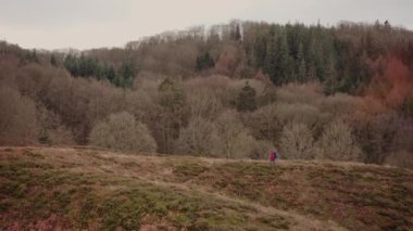Side View Through the Grass of a Tourist Hiking Along the Hills in Himmelbjerget Area, Denmark. Wide Panoramic Shot