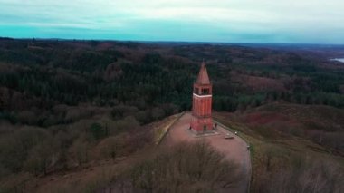 Aerial Over Red Brick Tower and Observation Point on the Top of Himmelbjerget Hill in the Evening at Sunset. Orbital Panoramic Shot