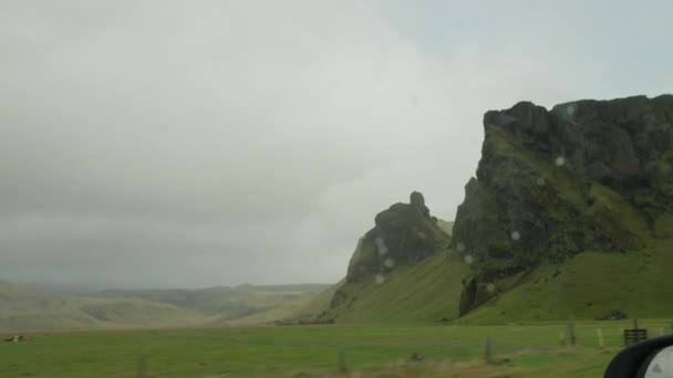 View Car Window Driving Green Fields Mountains Iceland Rainy Day — Video