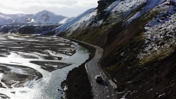 Aerial Car Driving Dirt Road River Snow Capped Mountains Iceland — Stockvideo