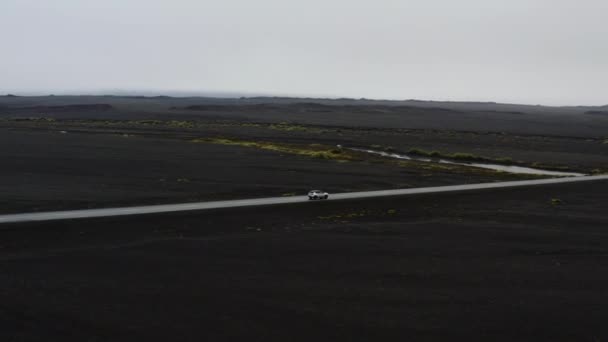 Aerial Car Driving Asphalt Road Black Lava Fields Surreal Landscape — Stockvideo