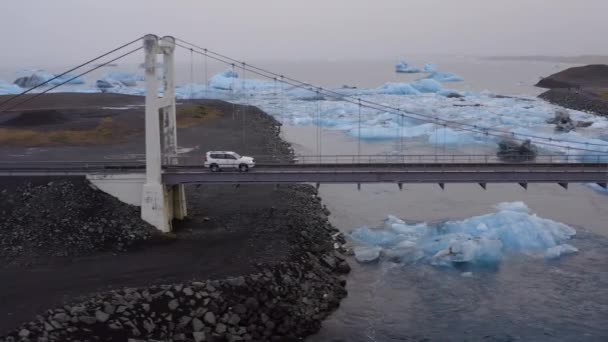 Aerial Car Driving Cable Bridge Glacial River Large Ice Splinters — Video Stock