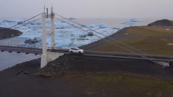Aerial Car Drives Cable Bridge Glacial River Large Ice Splinters — Stockvideo