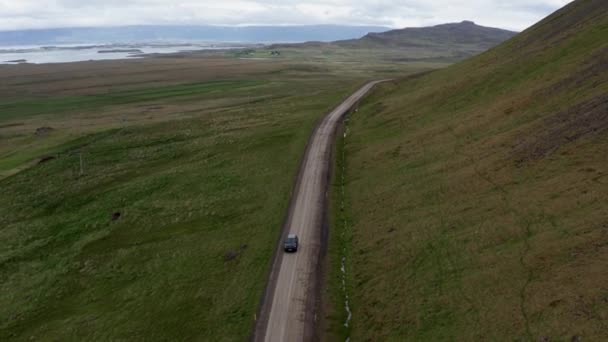 Aerial Car Driving Empty Rural Road Green Fields Iceland Beautiful — Vídeos de Stock