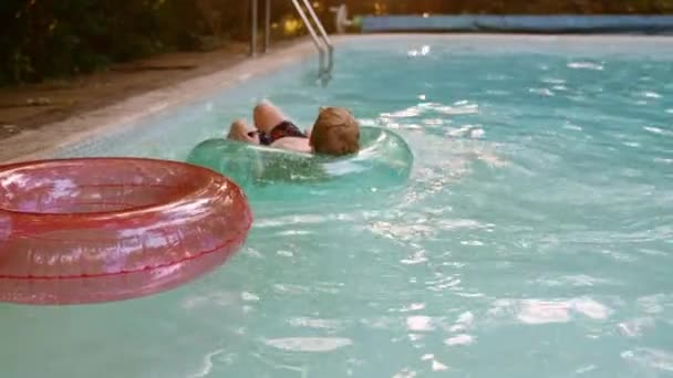 Boy Laying Inflatable Circle Floating Pool Summer Vacation Slow Motion — Vídeo de stock