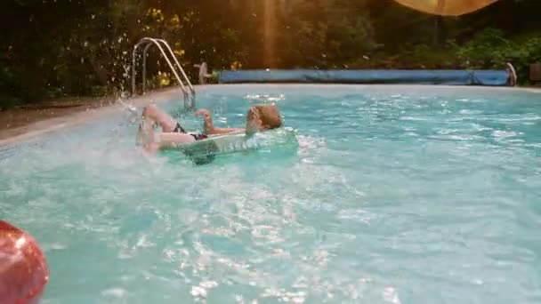 Boy Lays Inflatable Circle Splashing Water His Feet Pool Summer — Vídeo de stock