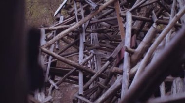 Handheld Medium Tilt Up Shot Of Wooden Structure At Beach