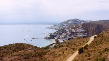 Aerial view of Famous Coastal Mediterranean Town of Roses, Spain. Amazing Seascape. Pamoramic Wide Shot. Camera Moves Forwards