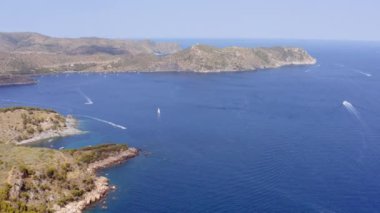 Aerial of Mountains and Sea with Yachts Near Mediterranean Town of Roses, Spain. Amazing Seascape. Panning Wide Shot