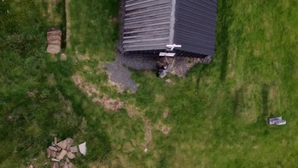 Aerial Top View Man Opens White Doors Little Black House — Video Stock