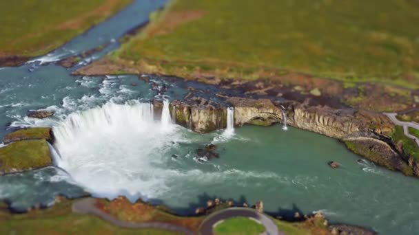 Wide Tilt Shift Drone Shot Panning Green Landscape Surrounding Godafoss — стоковое видео