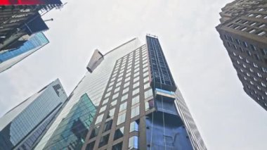 Wide Low Angle Dolly Shot Of Modern Skyscraper Reflecting The City, New York, North America