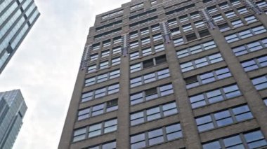Low Angle Point Of View Shot Passing New York Buildings Under Cloudy Sky
