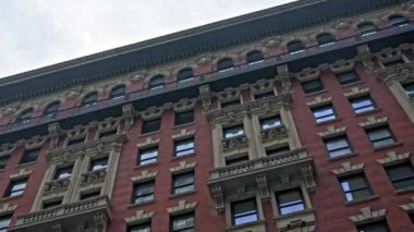 Passing Ornate New York Apartment Building Under Cloudy Sky