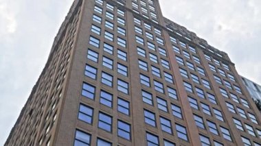 Low Angle Point Of View Shot Passing New York Buildings Under Cloudy Sky