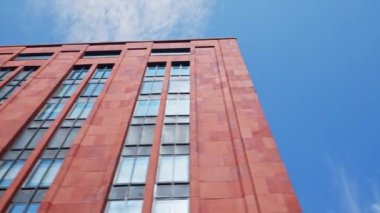 Low Angle Wide Point Of View Shot Moving Under New York City Red Building Under Blue Sky