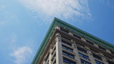 Low Angle Wide Point Of View Shot Moving Under New York City Apartment Block Under Blue Sky
