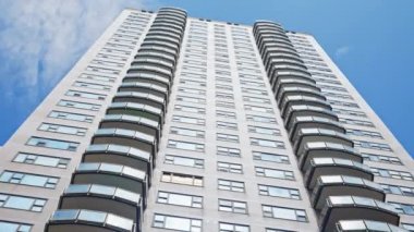 Low Angle Wide Point Of View Shot Moving Under New York City Blocks Of Apartments Under Blue Sky