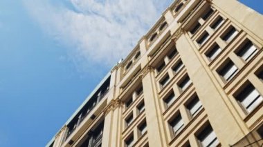 Low Angle Wide Point Of View Shot Moving Under New York City Apartment Block Under Blue Sky