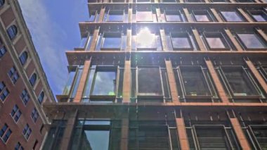 Low Angle Wide Panning Shot Of New York City Buildings And Apartments Under Blue Sky